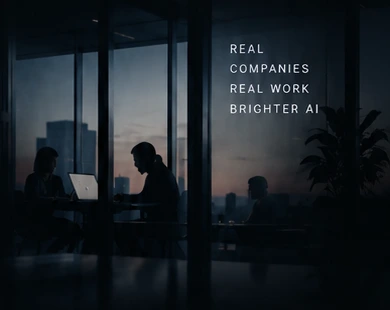 Colleagues working in a glass-walled office at dusk